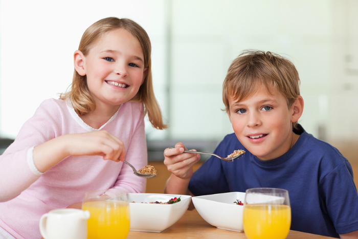 bigstock-Children-having-breakfast-in-a-27430826