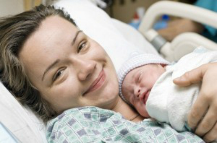 newborn-baby-and-smiling-mom_resized-300x198