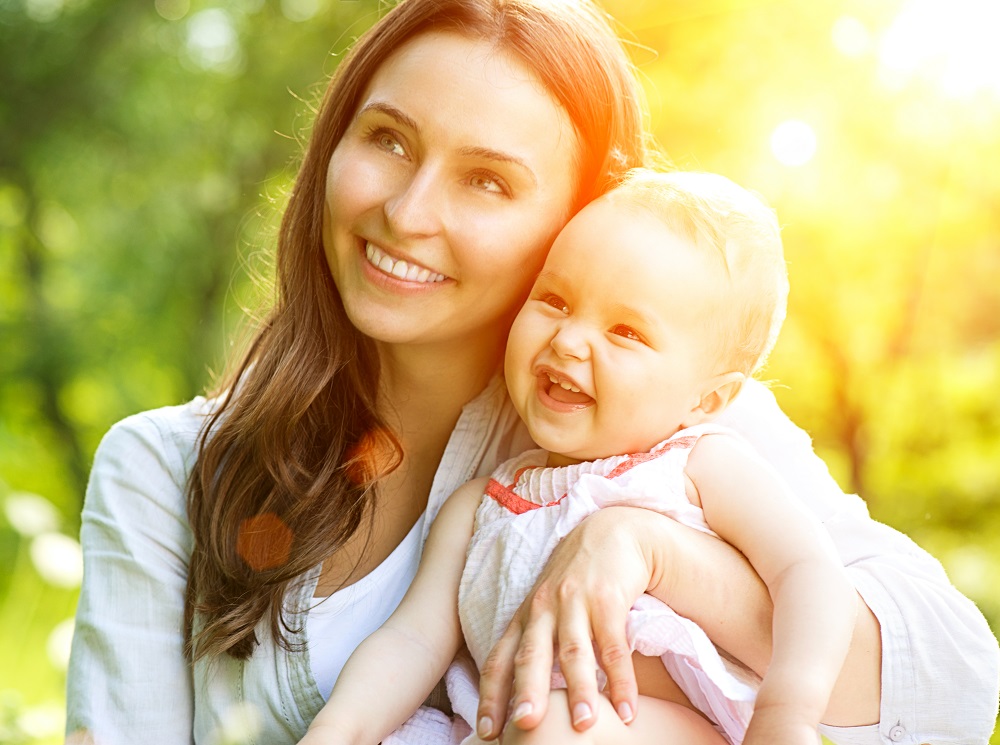 Beautiful Mother And Baby outdoors. Nature. Beauty Mum and her C