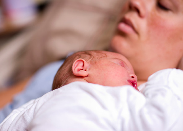 sleeping newborn baby, exhausted mother.