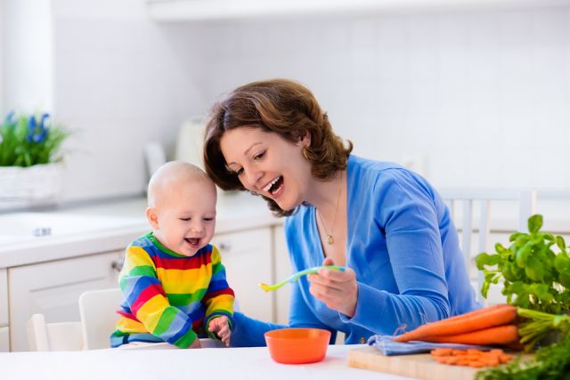 bigstock-Mother-Feeding-Baby-First-Soli-119473478