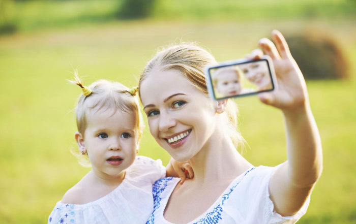 mother-baby-daughter-photographing-selfie-themselves-by-mobile-phone