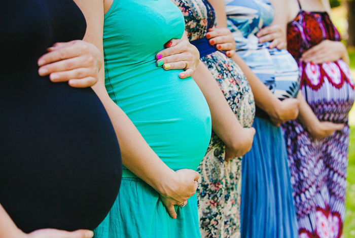 group-of-pregnant-women-holding-bellies