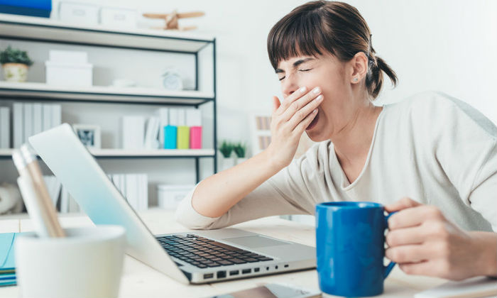 bigstock-tired-woman-at-office-desk-119626298