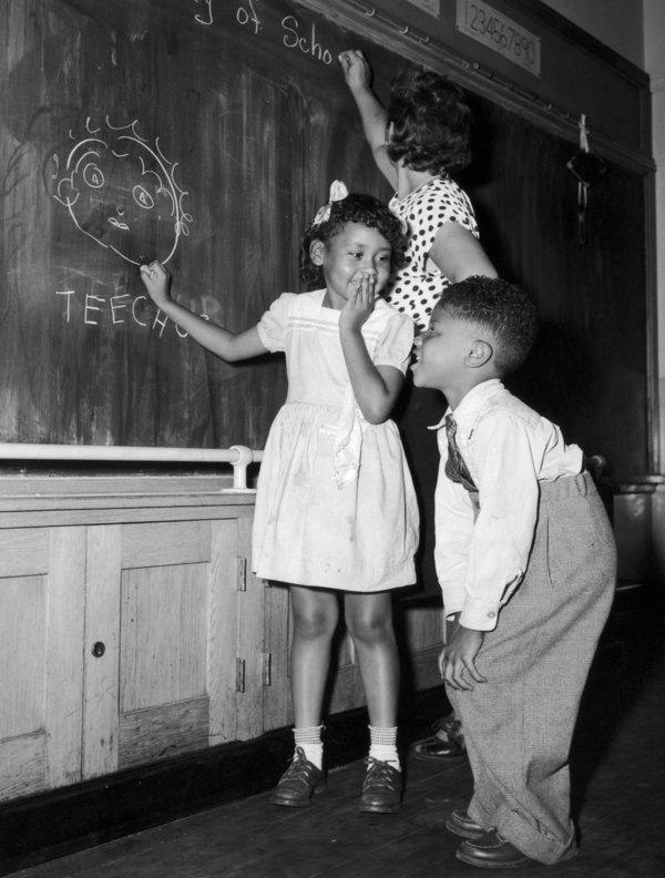 13th September 1948, Joyce Payne and Vincent Baker draw an unflattering portrait of their teacher on their first day at a Harlem School, New York. (Photo by Al Gretz/FPG/Getty Images)